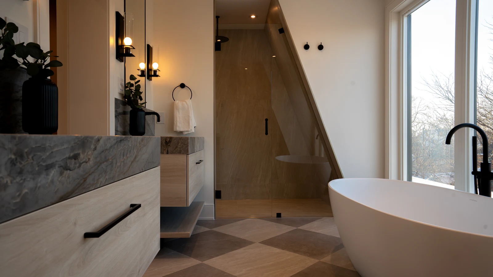 Modern bathroom with a freestanding tub and a large-format checkerboard porcelain tile floor