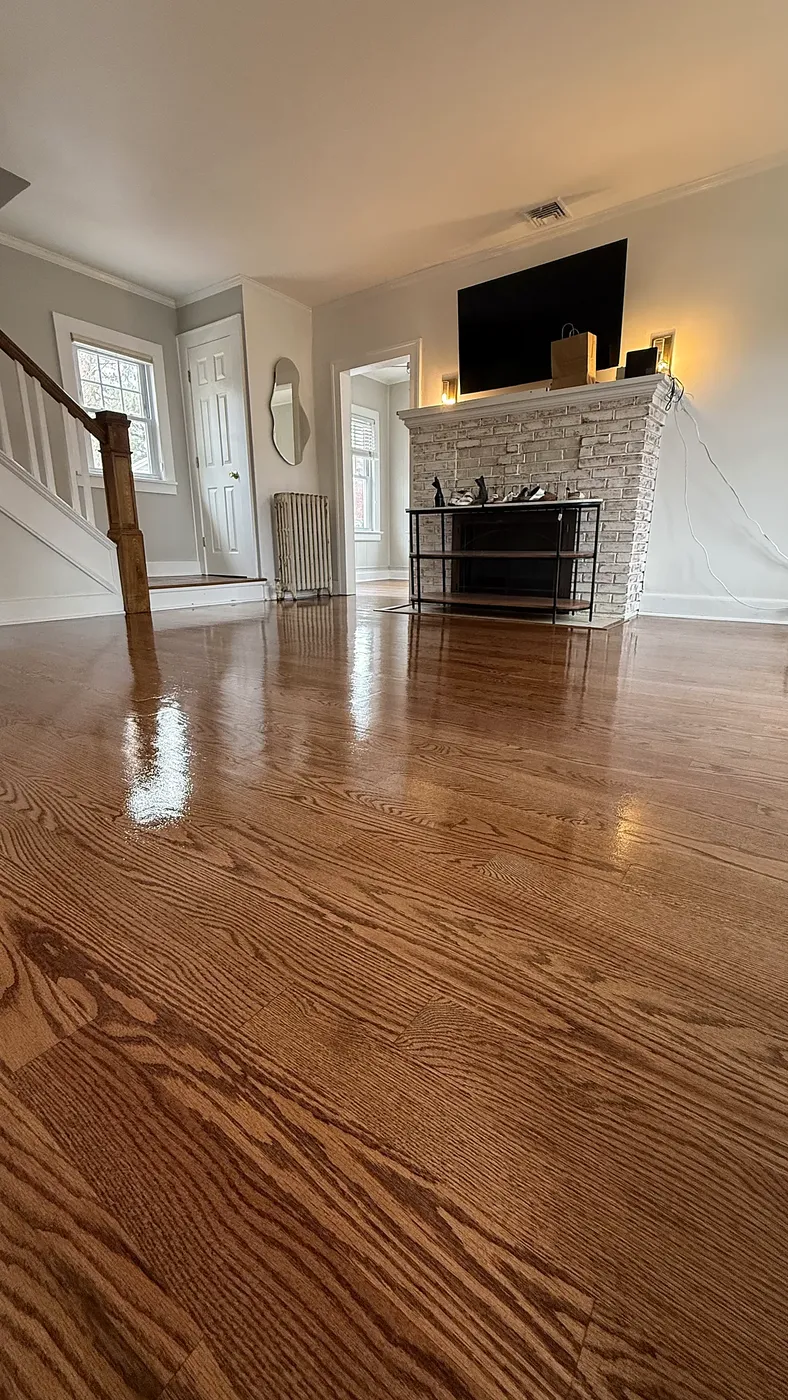 Hardwood Floor by a Whitewashed Brick Fireplace